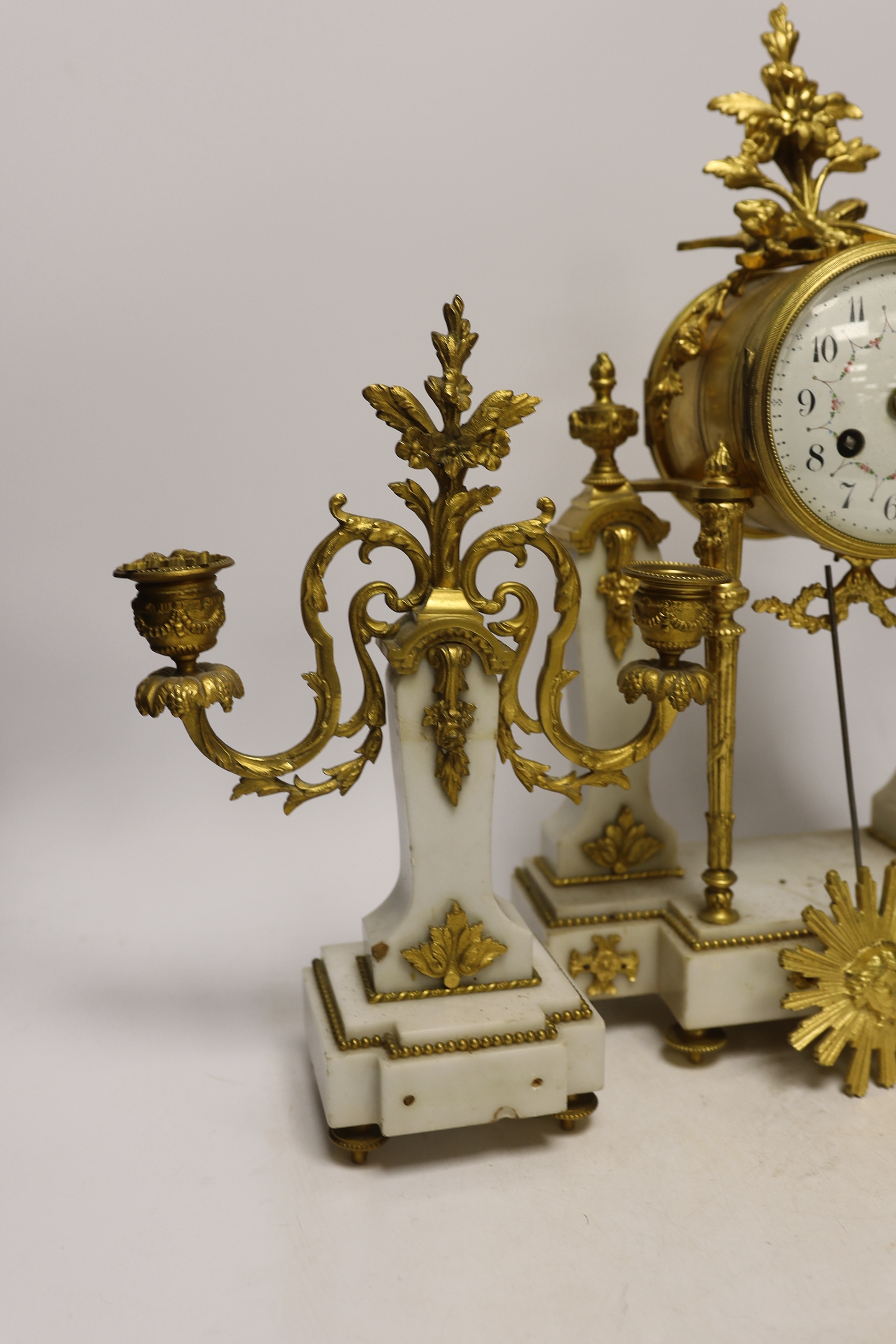 An early 20th century white marble and ormolu clock garniture with Arabic enamelled dial, 42cm high